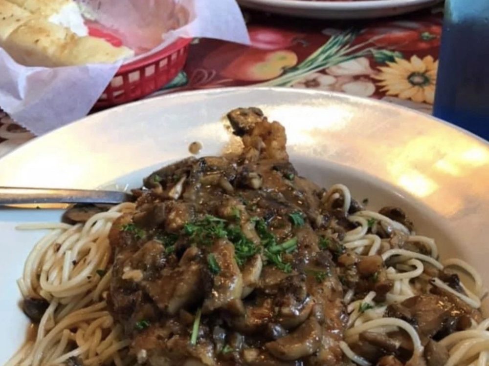 Pasta dish with mushroom sauce over spaghetti