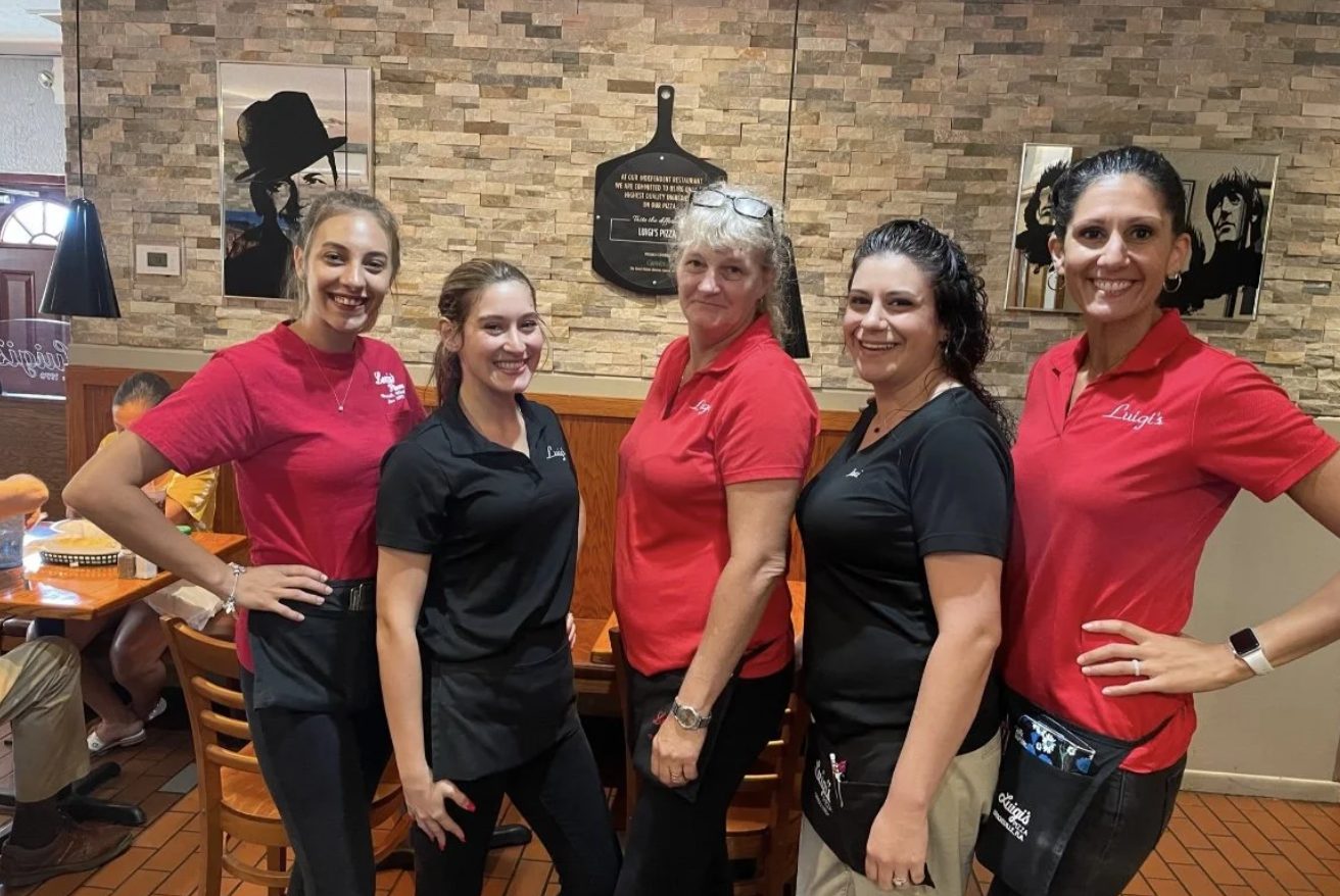 The team at Luigi's Pizza in the dining room
